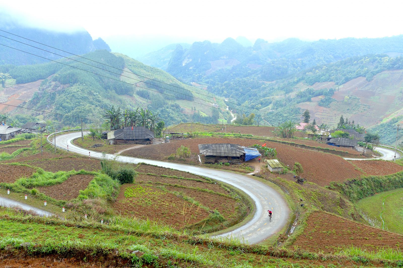 cyclist-riding-through-the-dramatic-mountains-of-Ha-Giang-Loop-in-northern-Vietnam